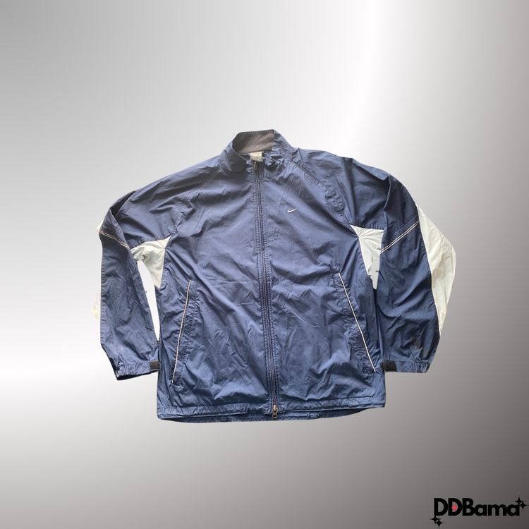 Vintage navy blue Nike windbreaker jacket with white accents